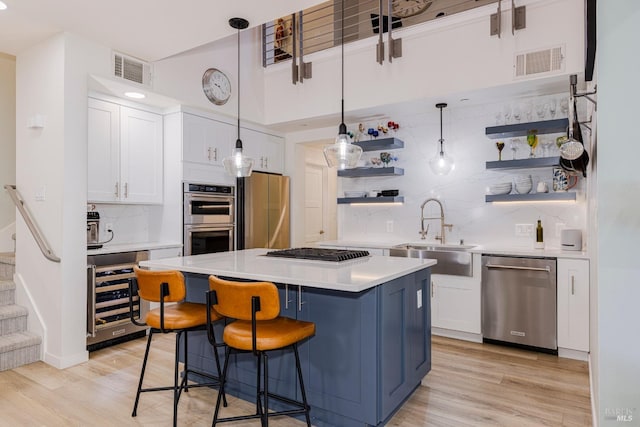 kitchen featuring wine cooler, open shelves, stainless steel appliances, light countertops, and white cabinets