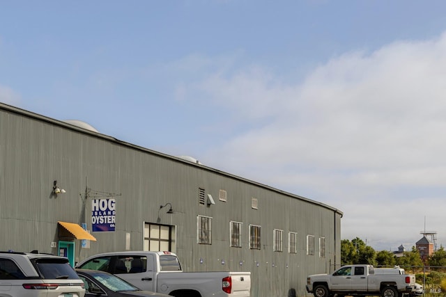 view of building exterior featuring uncovered parking