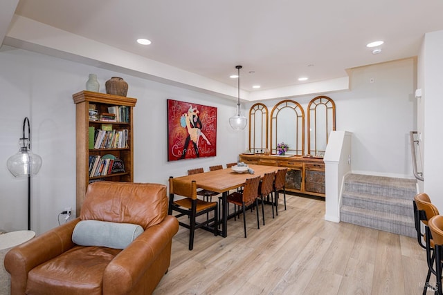 dining area featuring light wood-type flooring, stairway, and recessed lighting