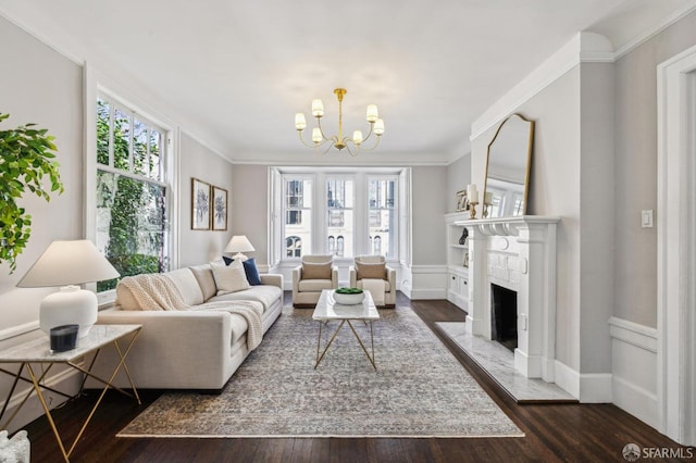 living room featuring a notable chandelier, a premium fireplace, dark hardwood / wood-style flooring, and a wealth of natural light