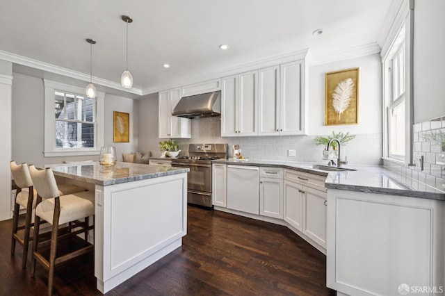 kitchen featuring white cabinetry, a center island, high end range, and ventilation hood