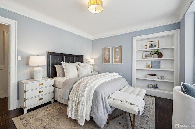 bedroom featuring ornamental molding and dark hardwood / wood-style floors