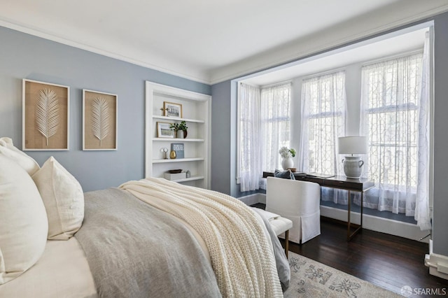 bedroom with crown molding and dark hardwood / wood-style floors