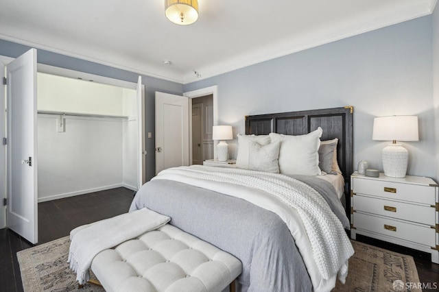 bedroom with dark hardwood / wood-style flooring and a closet