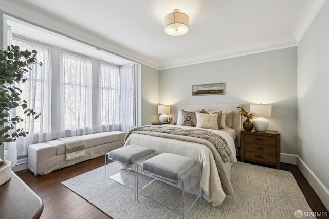 bedroom with crown molding and dark hardwood / wood-style floors