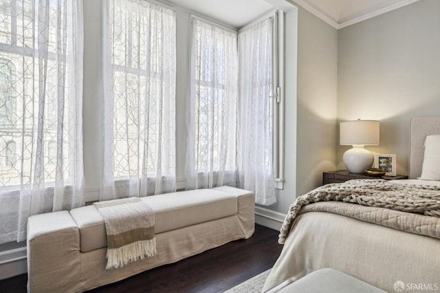 bedroom with crown molding and dark hardwood / wood-style flooring