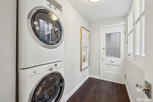 laundry room featuring stacked washing maching and dryer and dark hardwood / wood-style flooring