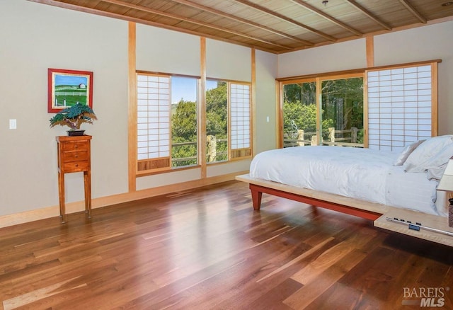 bedroom with hardwood / wood-style floors and wood ceiling