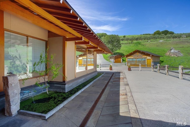 view of patio / terrace with an outbuilding