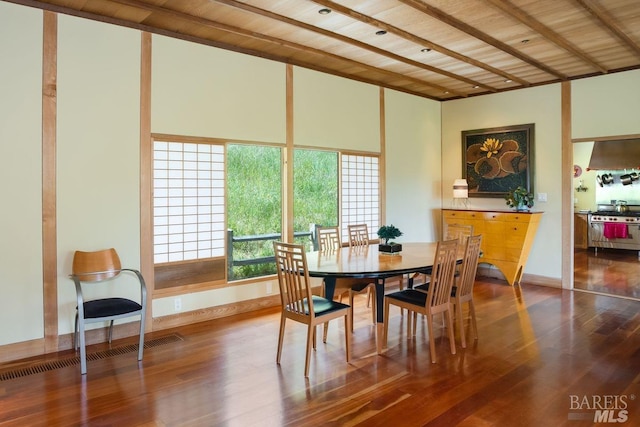 dining space with wood ceiling, beam ceiling, and hardwood / wood-style flooring