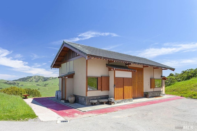 view of property exterior with a mountain view