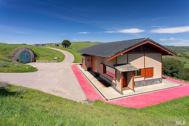 rear view of property featuring a lawn