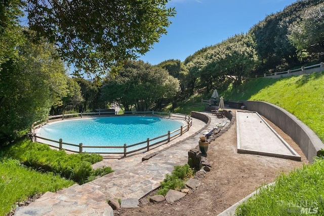 view of swimming pool with pool water feature