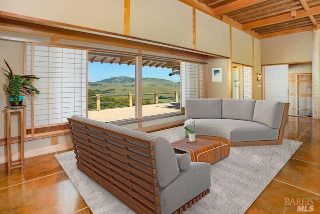 living room featuring a high ceiling and a mountain view