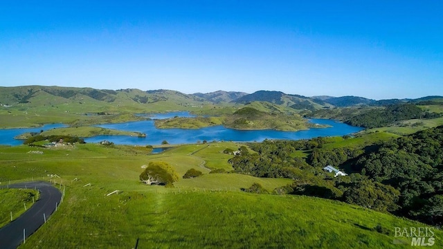 aerial view featuring a water and mountain view