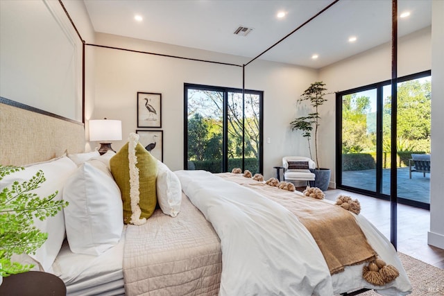 bedroom with access to exterior and hardwood / wood-style flooring