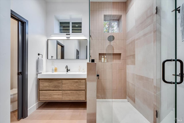 bathroom featuring vanity, toilet, and walk in shower