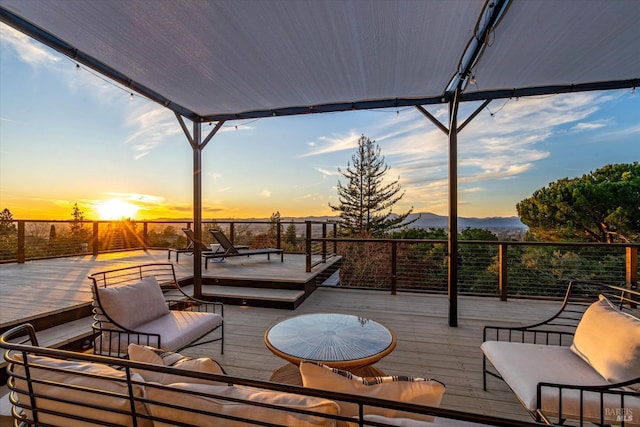 deck at dusk with an outdoor living space