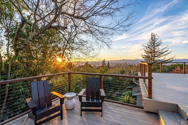 deck at dusk with a mountain view