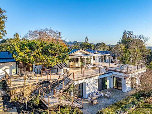 back of house featuring outdoor lounge area and a patio area