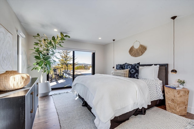 bedroom featuring dark hardwood / wood-style floors and access to outside