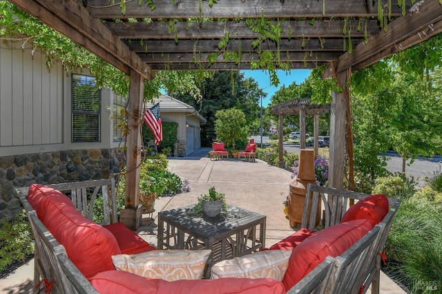 view of patio / terrace featuring a pergola, a garage, and an outdoor living space