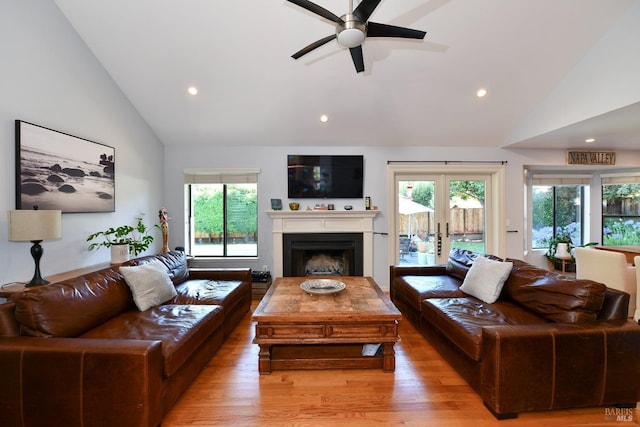 living area with a fireplace, light wood-type flooring, recessed lighting, and a ceiling fan