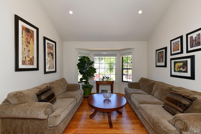 living room with light wood finished floors, lofted ceiling, and recessed lighting