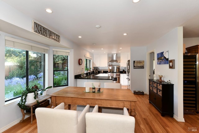 dining space featuring light wood finished floors, baseboards, and recessed lighting