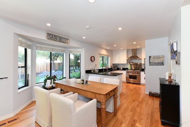 dining space with light wood-type flooring, recessed lighting, baseboards, and visible vents