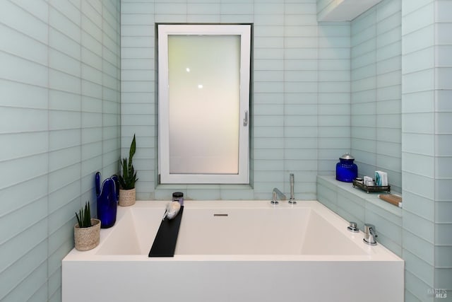 full bathroom featuring tile walls and a garden tub