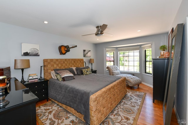 bedroom featuring light wood finished floors, baseboards, ceiling fan, and recessed lighting