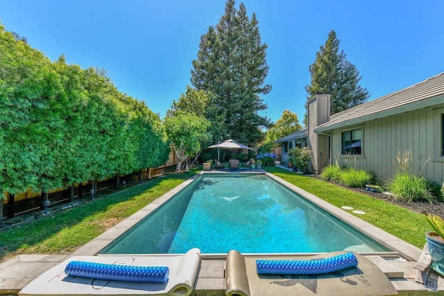 pool with a fenced backyard and a patio area
