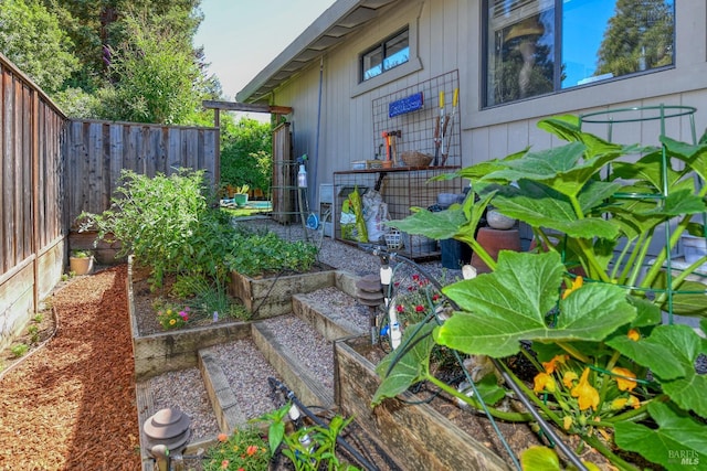 view of yard with a garden and fence private yard