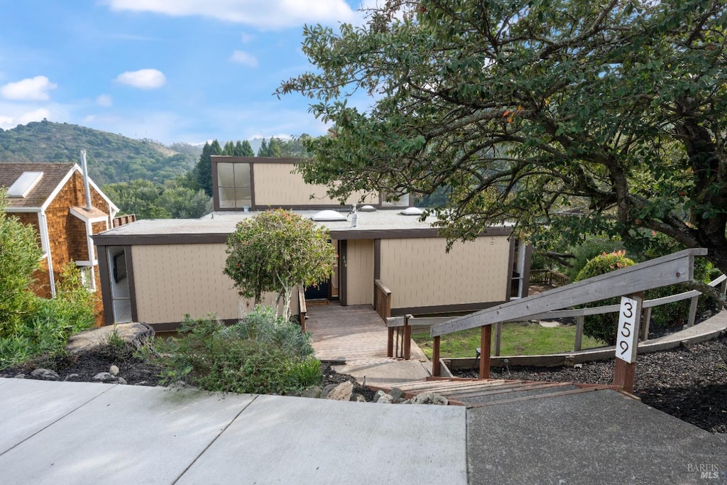 back of property featuring a mountain view