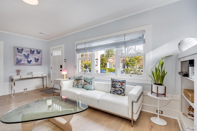 living room featuring ornamental molding and light hardwood / wood-style floors