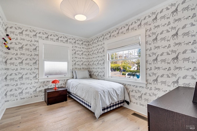 bedroom featuring crown molding and light wood-type flooring