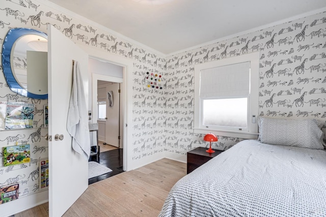 bedroom with hardwood / wood-style flooring and ornamental molding