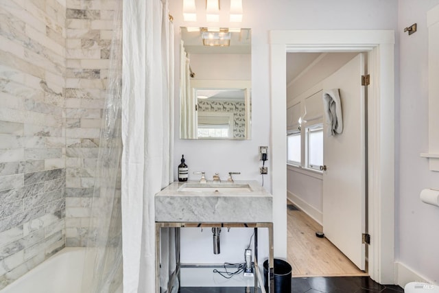 bathroom with sink and shower / bathtub combination with curtain