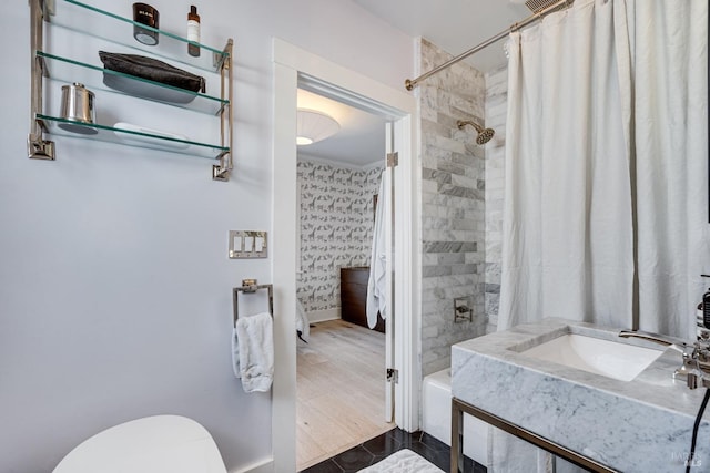 full bathroom featuring sink, shower / bath combination with curtain, and toilet