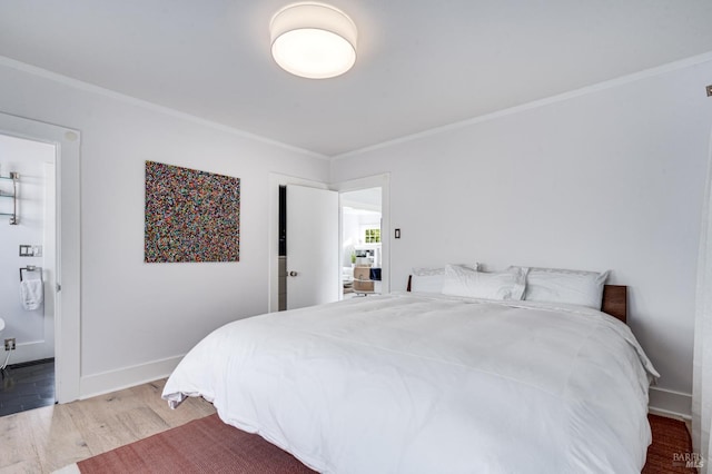 bedroom with wood-type flooring and ornamental molding