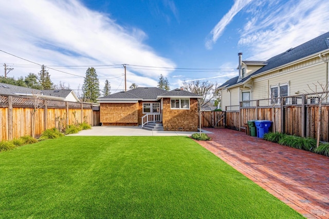 back of house with a lawn and a patio