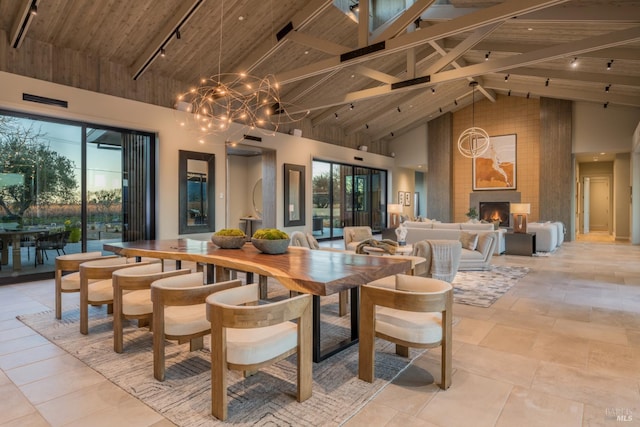 1212 Oak Knoll Ave, Napa, CA 94558 - dining room with track lighting, high vaulted ceiling, wooden ceiling with exposed beams, a fireplace, and a chandelier