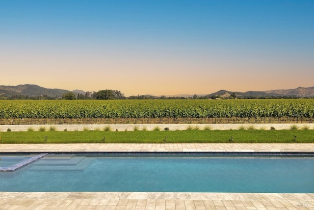 1212 Oak Knoll Ave, Napa, CA 94558 - pool at dusk featuring agricultural plots, a view of rural / pastoral area, a mountain view, and a pool with connected hot tub