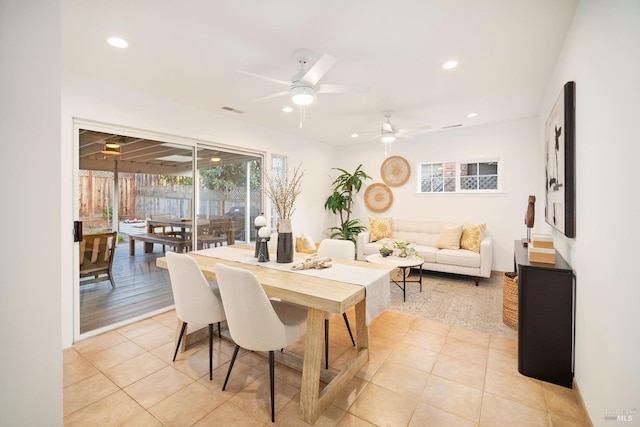 tiled dining space featuring ceiling fan