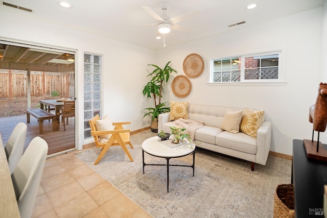 living room featuring light tile patterned flooring and ceiling fan