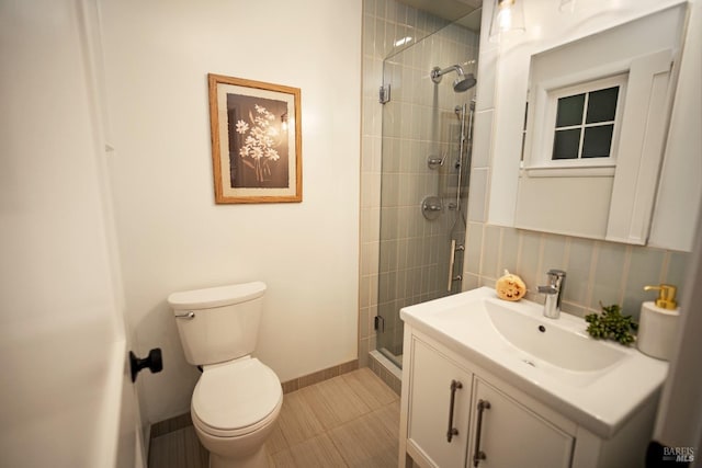 bathroom with tile patterned floors, vanity, toilet, and a shower with door