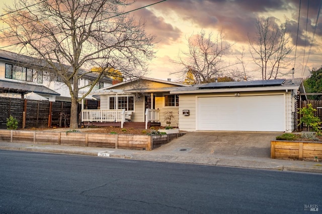 single story home featuring a garage and solar panels