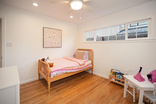 bedroom with ceiling fan and light hardwood / wood-style floors