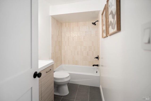 full bathroom with tile patterned flooring, vanity, tiled shower / bath, and toilet